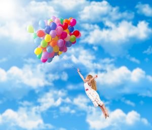 philosophy sports balloons 300x256 Child flies on the balloons. Blue sky, clouds. A little girl in a white dress